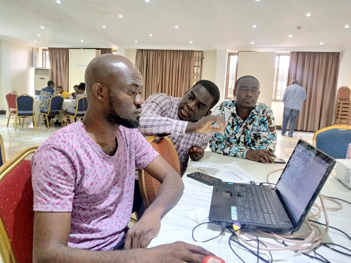 CBT experts in collaborative review around a laptop