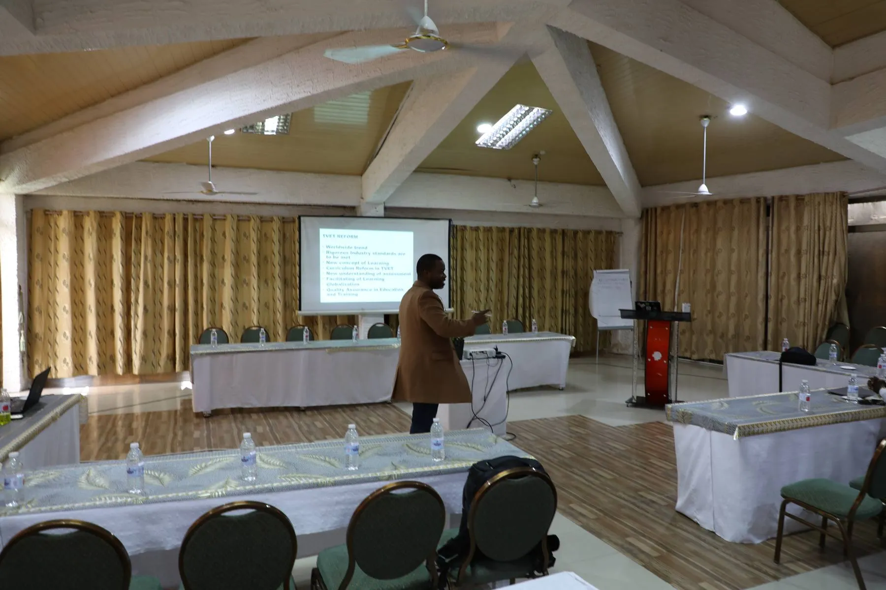Facilitator presenting from the podium at a CBT workshop