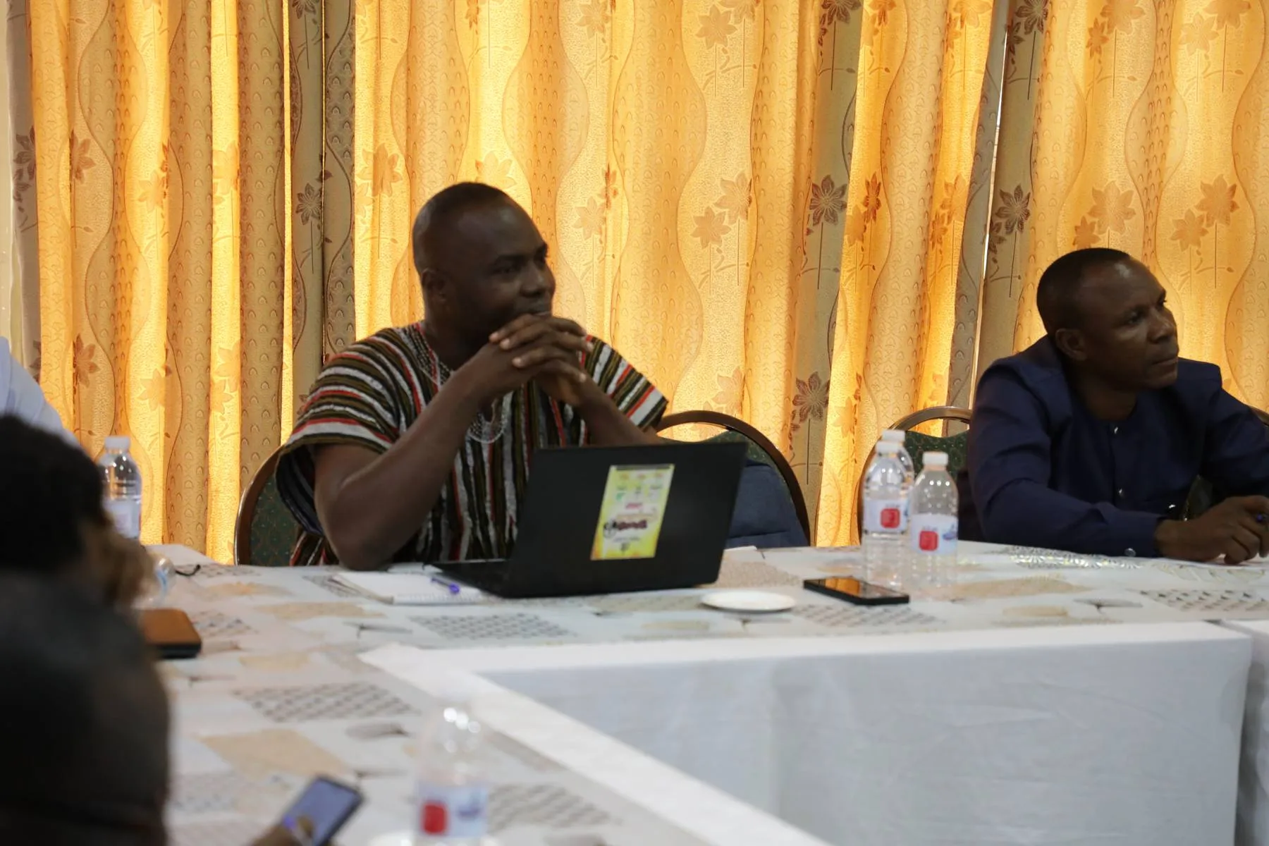 Delegates working on laptops at a TVET workshop