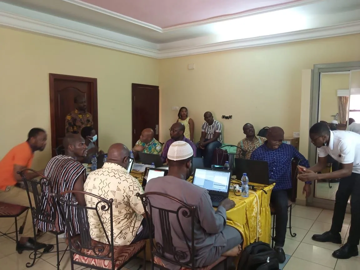 TVET experts working on laptops during a curriculum workshop