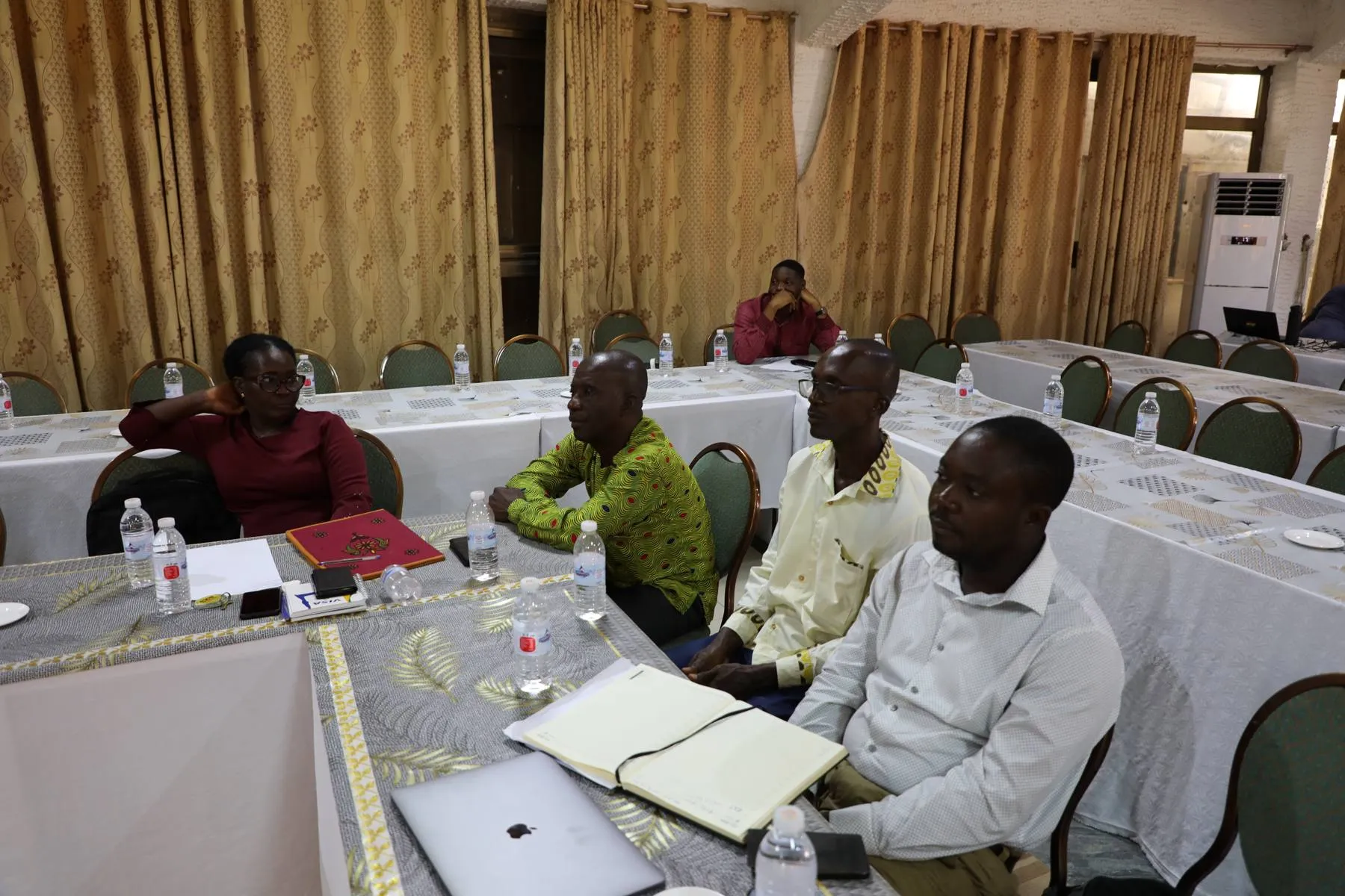 TVET workshop participants seated around tables in discussion